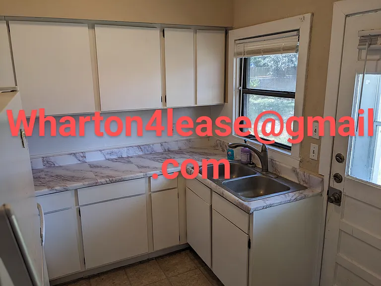 Kitchen complete with refrigerator, stove, and microwave