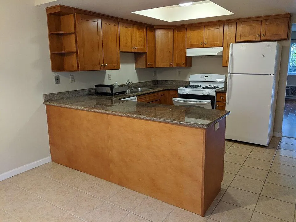 Kitchen with custom wood cabinets/granite countertops, and appliances