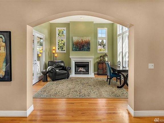 Formal sitting room with gas fireplace and French doors leading to the private courtyard. 