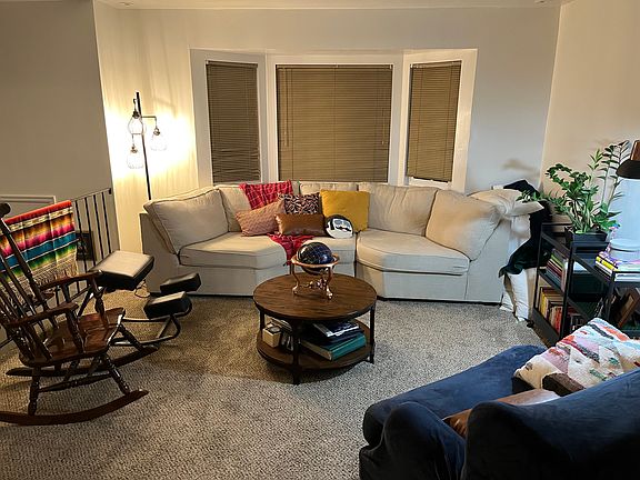 Upstairs Living room - example furnishings from previous tenant (couch, coffee table, and rocking chair remaining as furnishing for future tenant)