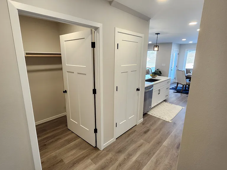 Closet space off the hallway from the garage entrance into kitchen. (Pictures are of another unit with similar finishes and features.)