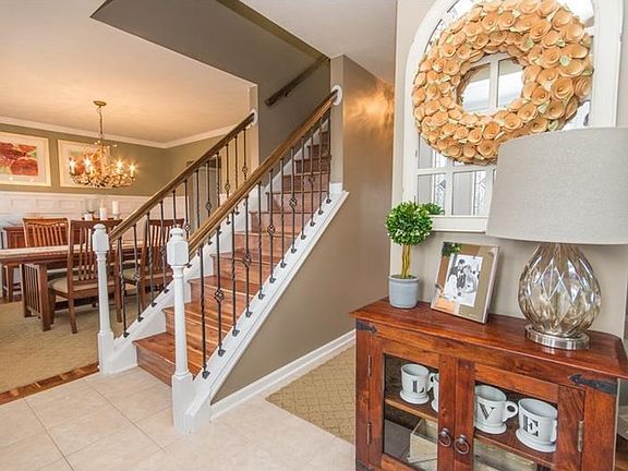 This striking entry way shows off the beautiful stairway with 3/4" hardwood flooring, rod iron and o