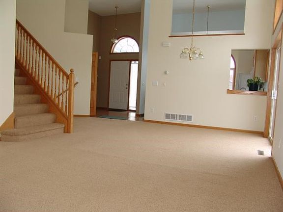 View from far end of living room looking back toward entry and kitchen.  Note pass through window from kitchen on right