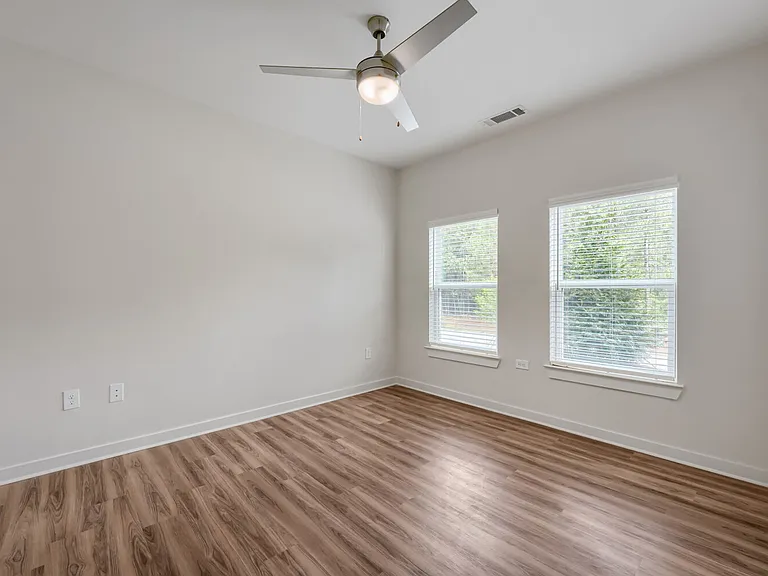 Bedroom with windows and ceiling fan