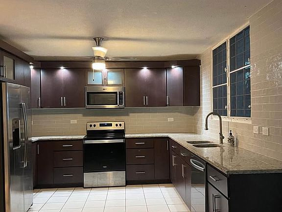 kitchen with all appliance including dishwasher, refrigerator,microwave and stove range.