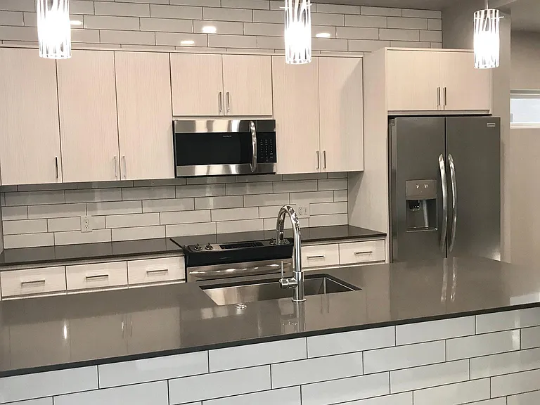 Light and bright, modern kitchen with stainless steel Kitchenaid appliances.