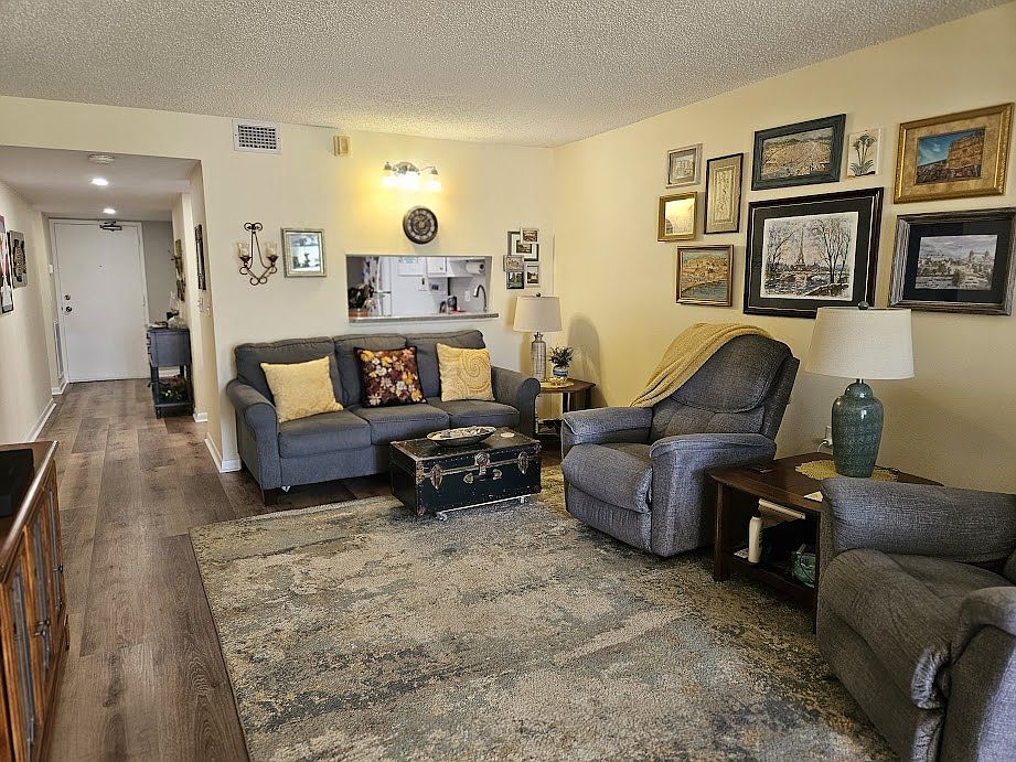 Living room sofa is a queen sleeper. Has a recliner to relax while watching a big screen TV.