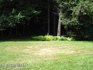 Backyard has large Wooded area also