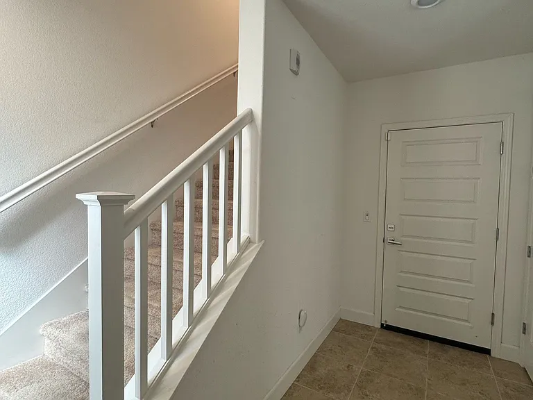 Door to garage and stair to upstairs once enter front door