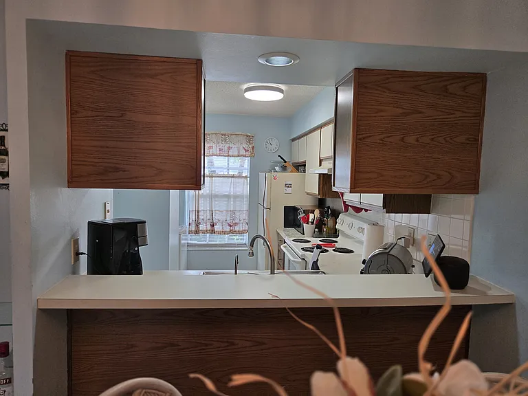 APPLIANCES IN THE FULLY EQUIPPED KITCHEN INCLUDE A DISHWASHER AND STACKABLE WASHER DRYER.