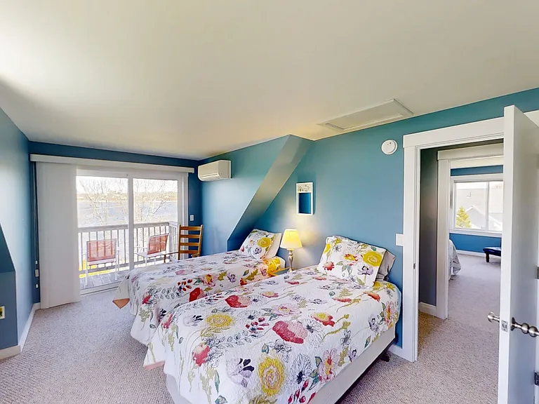 Second bedroom with 2 twin beds, ensuite half bath and balcony with ocean view.