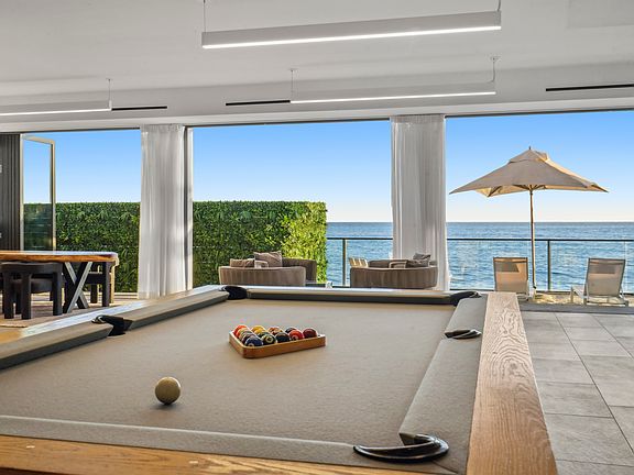 Challenge friends to a game by the beach _ the pool table awaits your next victory.