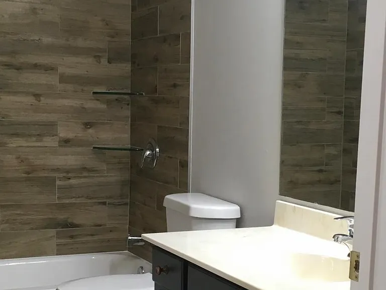 Clean white tub. New toilet