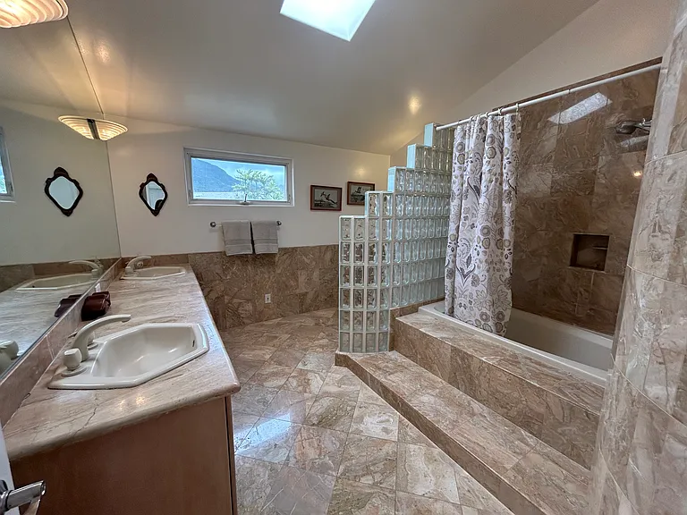 Second Full bathroom located with marble finishes throughout located upstairs