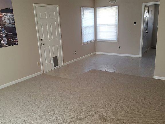 Living Room, Dining Room, and Door to Garage