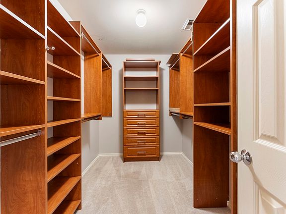 Massive walk-in closet with built-in drawers and shelving
