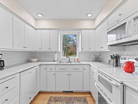 Kitchen overlooking backyard, dishwasher, double stove, refrigerator, microwave