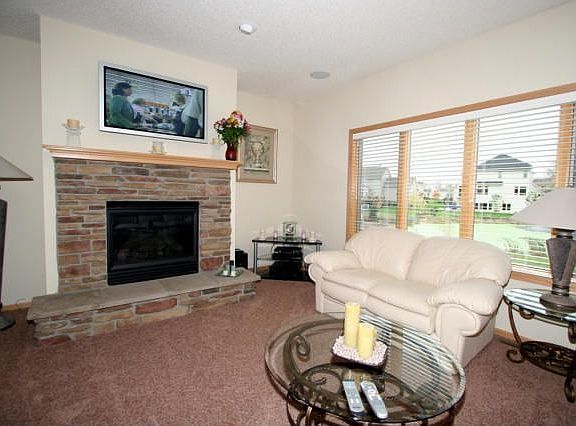 The great room has a stone surround gas fireplace and 42 inch plasma tv.