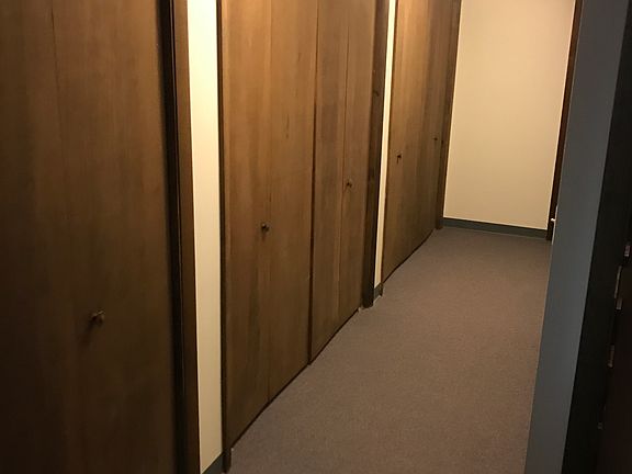 Down stairs hallway with plenty of storage