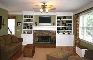 Spacious family room with stone surround fireplace and built in bookcases!
