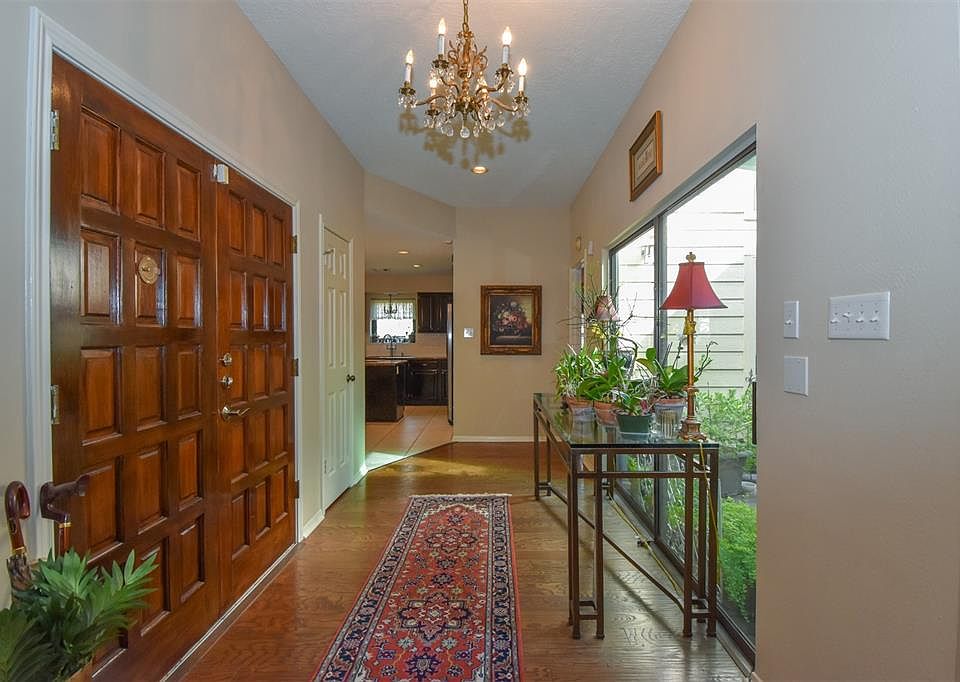 Enter through beautiful double doors to a light and bright front foyer. Nice views of a lovely landscaped atrium. Rich wood floors in the entry and living and dining rooms.