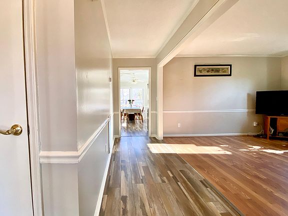 Main hallway from front door to kitchen, with family room on right
