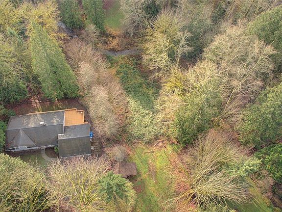 Such a beautiful setting with privacy, acreage and a creek!