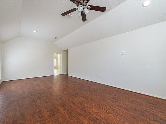 Once through the leaded glass front door, you will find this formal living and dining room combination with engineered wood flooring. The wood continues into the hallway and den. This area is spacious with lots of natural light.