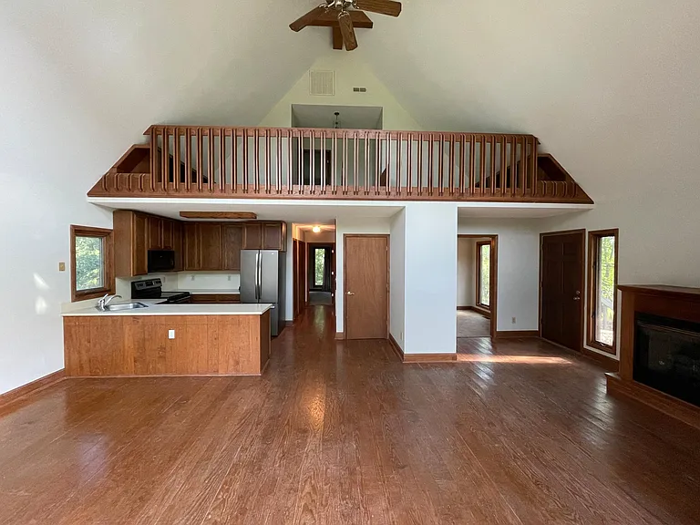 Looking from the windows to the kitchen, dining room and bedroom hallway and stairs to loft.
