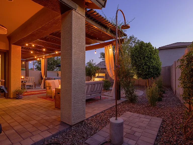 The backyard includes an outdoor shower-- great for rinsing off right before you get into the hot tub.