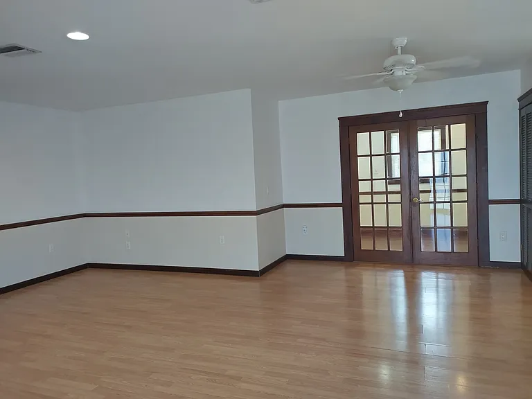 Living area with french doors leading to the main bedroom.
