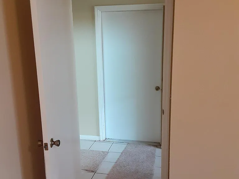 Entrance to master bedroom, across the hall is garage entrance.