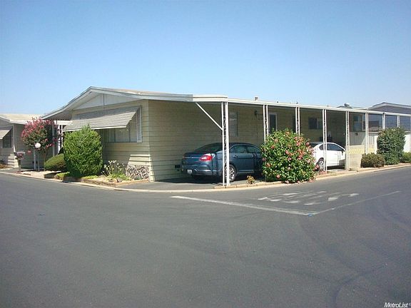 another view of the home noting the carport area.