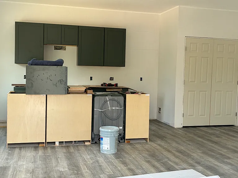 Spacious open concept kitchen and living space. Kitchen will have large island with eating space and stainless steel appliances. Countertops will be a white, grey, and black quartz.