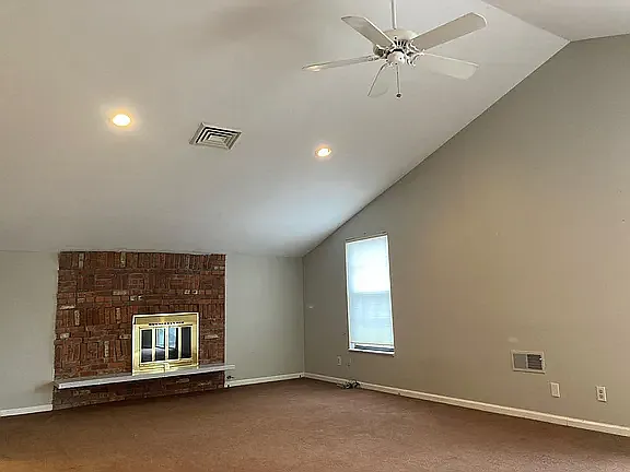Spacious primary retreat featuring vaulted ceilings, fireplace, and abundant natural light.
