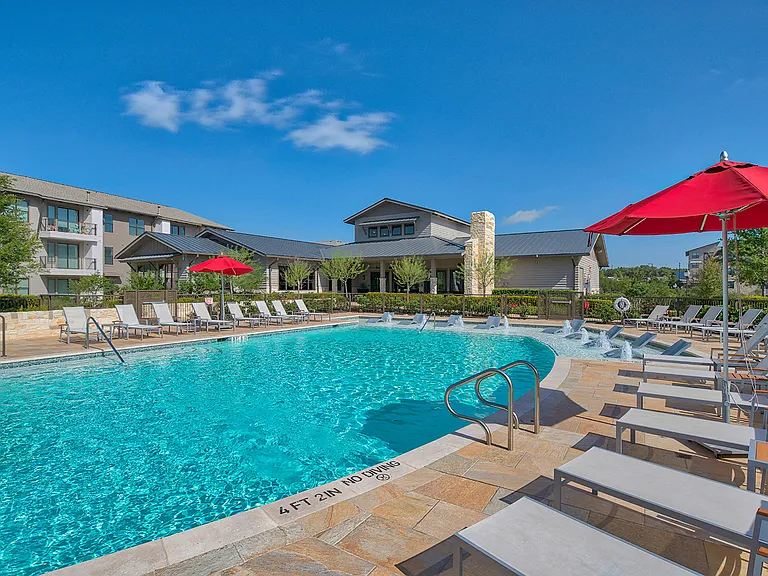 Infinity-edge pool with baja sun shelf and cabanas