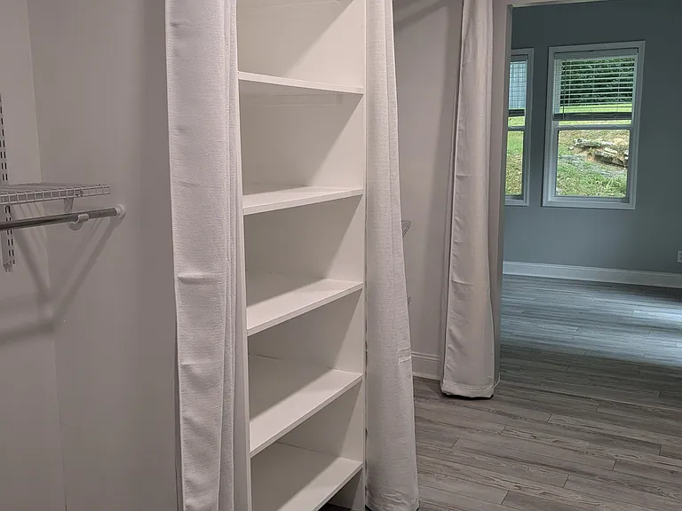 Walk-in closet with two separate closet spaces and tons of shelf storage