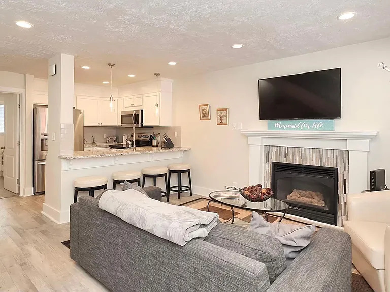 Living room showing entry way to downstairs bedroom