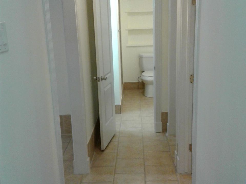 Hallway from inside front door. Once inside, there are 2 steps down in hallway going towards bath.