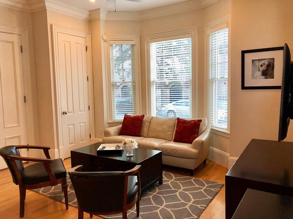 Open floor plan connects living area to the kitchen. Lots of light with large bay windows.