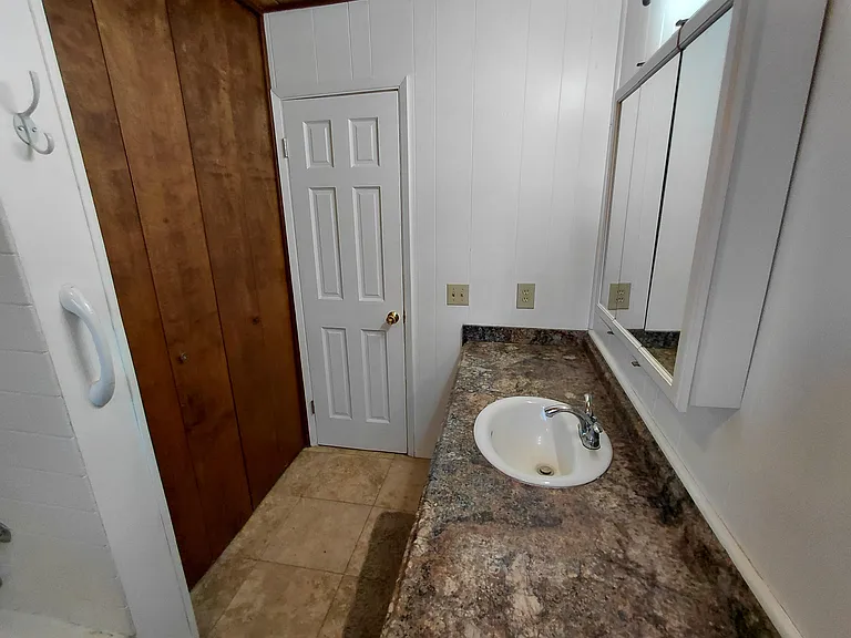 Bright, updated bathroom with generous storage.