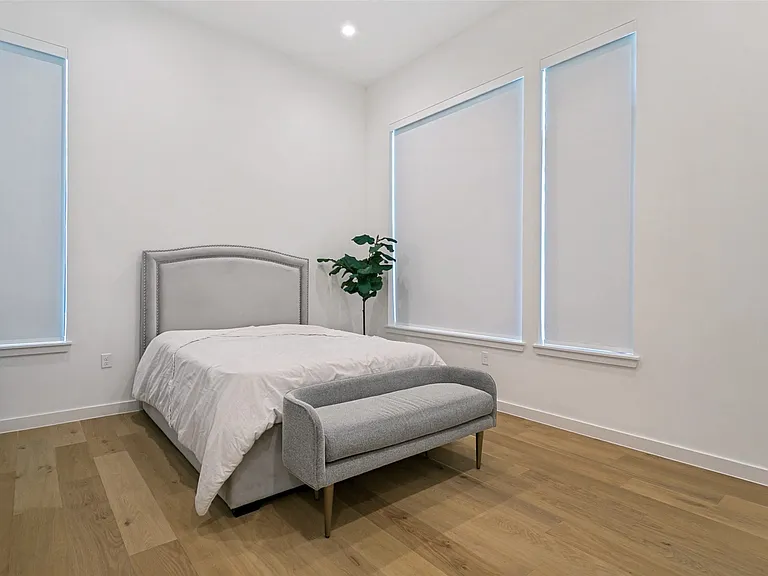 Primary bedroom with automatic blinds and en suite primary bathroom. (2nd floor)