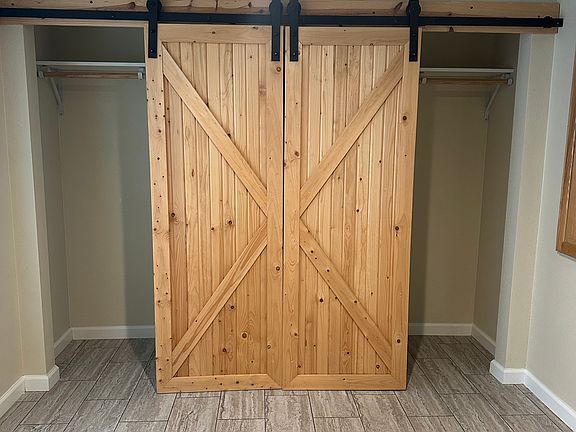 Closet in bedroom. sliding doors with dresser in center.