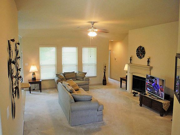 Wall of windows that bring in plenty of natural light in the living area.