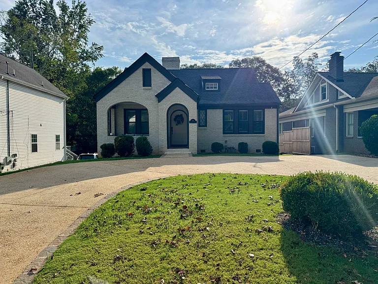 Exterior of home with large circular driveway