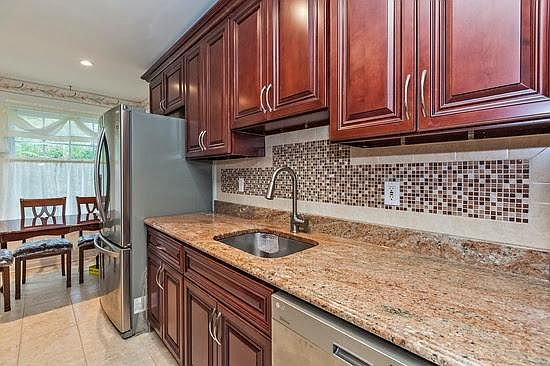 Kitchen with LG Stainless Steel applaince and cabinets, Granite Countertops with OG design edges. This modem complemented with granite and tile famed back splash, stainless steel deep sink with swan type faucet.