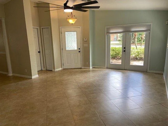 TV Room Looking Out towards front yard, French Doors as well.
