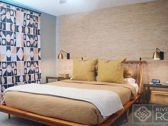 Brand new queen-size mattress and platform bed with wall sconces perfect for reading before bed.