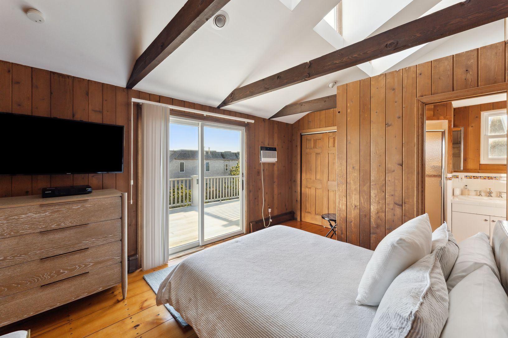 One bedroom with access to the upstairs deck