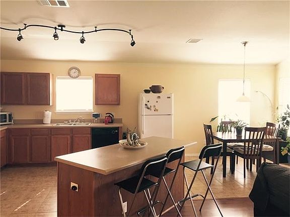 Huge kitchen with center island, breakfast area looks out into backyard.